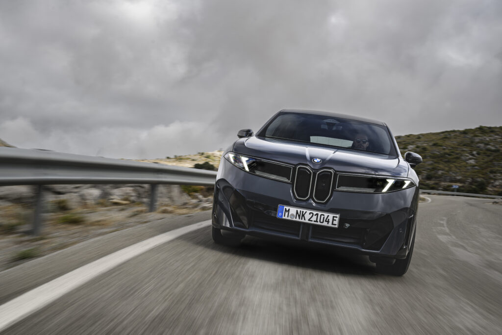 2027 BMW iX3 head on driving